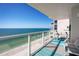 Inviting balcony with comfortable seating overlooking the ocean and sandy beach at 2425 Gulf Of Mexico Dr # 14B, Longboat Key, FL 34228