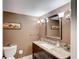 Charming half bathroom with granite countertop and warm lighting at 2425 Gulf Of Mexico Dr # 14B, Longboat Key, FL 34228