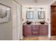 Bathroom featuring double sinks, granite countertop, and decorative mirrors at 2425 Gulf Of Mexico Dr # 14B, Longboat Key, FL 34228