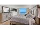 Bright bedroom with a coastal view, light wood furniture, and a flat-screen TV at 2425 Gulf Of Mexico Dr # 14B, Longboat Key, FL 34228