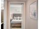 Bedroom features a gray wooden bed frame with ensuite bathroom at 2425 Gulf Of Mexico Dr # 14B, Longboat Key, FL 34228