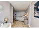 Bedroom featuring tiled floor, gray walls, and a spacious layout at 2425 Gulf Of Mexico Dr # 14B, Longboat Key, FL 34228