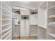 Spacious walk-in closet with custom shelving and an ironing board at 2425 Gulf Of Mexico Dr # 14B, Longboat Key, FL 34228