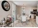 Dining area with seating for four, a modern chandelier, and a view of the ocean at 2425 Gulf Of Mexico Dr # 14B, Longboat Key, FL 34228