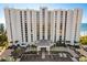 Expansive beachfront condo with covered parking, palm trees, and direct beach access at 2425 Gulf Of Mexico Dr # 14B, Longboat Key, FL 34228