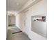 Hallway with carpeted floors, white walls and doors, including visible utility equipment at 2425 Gulf Of Mexico Dr # 14B, Longboat Key, FL 34228