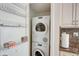 Efficient laundry area with stacked washer and dryer for easy convenience at 2425 Gulf Of Mexico Dr # 14B, Longboat Key, FL 34228
