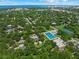 Aerial view of a neighborhood with mature trees and community pool at 2524 Tuttle Way, Sarasota, FL 34239