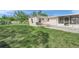 Spacious backyard features mature trees and a patio area at 2524 Tuttle Way, Sarasota, FL 34239