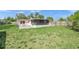 Spacious backyard with a patio area and well-maintained lawn at 2524 Tuttle Way, Sarasota, FL 34239