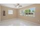 Bedroom with tile flooring, ceiling fan, and bright natural light from the window at 2524 Tuttle Way, Sarasota, FL 34239