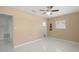 Neutral bedroom with tile flooring, ceiling fan, and an en suite bathroom at 2524 Tuttle Way, Sarasota, FL 34239