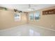 Bright bedroom features neutral walls, tile floors, ceiling fan and sunny windows at 2524 Tuttle Way, Sarasota, FL 34239