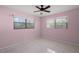 Pink bedroom featuring tile flooring, ceiling fan, and sunlit windows at 2524 Tuttle Way, Sarasota, FL 34239