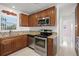 A well-lit kitchen featuring stainless steel appliances and granite countertops at 2524 Tuttle Way, Sarasota, FL 34239