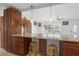 Breakfast bar with granite countertop, wooden stools, and pendant lighting at 2524 Tuttle Way, Sarasota, FL 34239