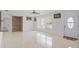 Bright living room with tile flooring, ceiling fan, and neutral paint at 2524 Tuttle Way, Sarasota, FL 34239