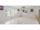 Bright living room with tile flooring, ceiling fan, and neutral paint at 2524 Tuttle Way, Sarasota, FL 34239