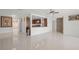 Spacious open-concept living area with tile floors and direct access to the kitchen at 2524 Tuttle Way, Sarasota, FL 34239