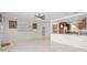 Open-concept living area with tile flooring, and direct views into the kitchen at 2524 Tuttle Way, Sarasota, FL 34239