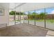 Enclosed patio with brick floors, sunny backyard access, and neutral walls at 2524 Tuttle Way, Sarasota, FL 34239
