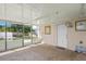 Enclosed patio with brick floors, a ceiling fan, and access to the backyard at 2524 Tuttle Way, Sarasota, FL 34239