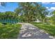 Scenic view of a pond with a fountain, bridge, and a paved walking path surrounded by lush greenery and mature trees at 2524 Tuttle Way, Sarasota, FL 34239