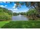 Picturesque view of the pond with a fountain, lush greenery, trees and a bridge. Great spot to unwind and enjoy nature at 2524 Tuttle Way, Sarasota, FL 34239