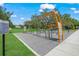 Outdoor fitness training area with exercise equipment, soft ground cover, and instructional signage for residents' fitness goals at 2524 Tuttle Way, Sarasota, FL 34239