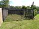 Backyard featuring a chain link enclosed area for pets and a lawn at 2787 Jay Pl, Sarasota, FL 34235