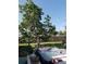 Backyard featuring a hot tub surrounded by lush greenery and a fenced perimeter at 2787 Jay Pl, Sarasota, FL 34235