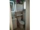 Cozy bathroom with a white toilet, vanity sink, tiled walls, and white storage cabinet at 2787 Jay Pl, Sarasota, FL 34235