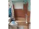 Bathroom featuring turtle-themed shower curtain and matching toilet seat, along with brown-tiled walls at 2787 Jay Pl, Sarasota, FL 34235