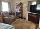 This bedroom features a leather recliner, shelving unit and large television at 2787 Jay Pl, Sarasota, FL 34235