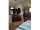 Bedroom featuring a dresser with baskets, a large mirror, and a glimpse of the bed at 2787 Jay Pl, Sarasota, FL 34235