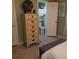 Bedroom featuring a tall, decorative wooden dresser and ensuite bathroom with tiled floor at 2787 Jay Pl, Sarasota, FL 34235