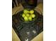 Fresh figs in a decorative glass bowl adorn a glass dining table, showcasing the home's elegant details at 2787 Jay Pl, Sarasota, FL 34235