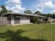Lovely single-story home boasts a metal roof, awning-shaded windows, and lush green lawn at 2787 Jay Pl, Sarasota, FL 34235
