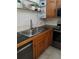 Kitchen with black countertops, stainless steel sink, and modern stainless steel appliances at 2787 Jay Pl, Sarasota, FL 34235