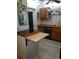 Kitchen with black countertop, stainless steel dishwasher, wooden cabinetry, and tile flooring at 2787 Jay Pl, Sarasota, FL 34235