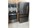 Kitchen featuring modern stainless steel appliances with built in microwave and stainless steel refrigerator at 2787 Jay Pl, Sarasota, FL 34235
