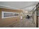 Enclosed back porch with wood flooring and ample space for outdoor relaxation and dining at 2820 Greenbriar St, Sarasota, FL 34237