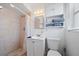 Well-lit bathroom featuring a shower, vanity with storage, and a toilet at 2820 Greenbriar St, Sarasota, FL 34237