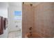 Cozy bathroom featuring tile shower with a tub and a window for natural light at 2820 Greenbriar St, Sarasota, FL 34237