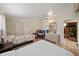 A bedroom with view into the living room's stone fireplace and ceiling fan at 2820 Greenbriar St, Sarasota, FL 34237