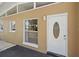 Home entrance features a secure white door, a window, and a light fixture providing a welcoming entry at 2820 Greenbriar St, Sarasota, FL 34237