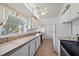 Bright kitchen featuring white cabinets, tile countertops, a large window, and tile flooring at 2820 Greenbriar St, Sarasota, FL 34237