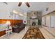 Cozy living room with a stone fireplace, wood-paneled accent wall, tile flooring, and comfortable seating at 2820 Greenbriar St, Sarasota, FL 34237