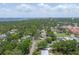 Expansive aerial view of a neighborhood with lush greenery and distant water views, showcasing community charm at 304 34Th W St, Bradenton, FL 34205