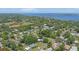 High-angle aerial view of a community featuring a sports field and views of the bay in the distance at 304 34Th W St, Bradenton, FL 34205